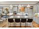 Gourmet kitchen featuring an oversized island with seating, designer lighting, and custom hood at 5357 Pembrey Dr, Denver, NC 28037