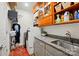 A laundry room featuring granite countertops, gray cabinets, and front-loading washer and dryer at 5357 Pembrey Dr, Denver, NC 28037