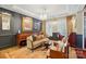 Elegant living room featuring dark wall paneling, a chandelier, and hardwood floors at 5357 Pembrey Dr, Denver, NC 28037