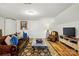 Cozy living room featuring a unique wooden sofa, stylish accents, and hardwood flooring at 5357 Pembrey Dr, Denver, NC 28037