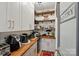 Walk-in pantry with open shelving, wood countertops, and ample storage space at 5357 Pembrey Dr, Denver, NC 28037
