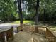 Backyard featuring a wooden deck, expansive yard, and wooded perimeter at 5458 Foxcroft Dr, Fort Lawn, SC 29714
