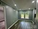 Serene bedroom with gray vinyl flooring, featuring two windows with views of the greenery at 5458 Foxcroft Dr, Fort Lawn, SC 29714