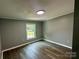Bedroom with hardwood floors, window view, neutral paint, and modern lighting at 5458 Foxcroft Dr, Fort Lawn, SC 29714