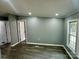 Cozy bedroom with gray walls, white trim, modern gray vinyl flooring, and ample natural light at 5458 Foxcroft Dr, Fort Lawn, SC 29714
