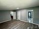 Large bedroom showcasing hardwood flooring, neutral walls, and access to bathroom and hallway at 5458 Foxcroft Dr, Fort Lawn, SC 29714