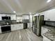 Modern kitchen featuring stainless steel appliances, granite countertops, and white cabinetry at 5458 Foxcroft Dr, Fort Lawn, SC 29714