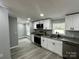 Well-equipped kitchen with stainless appliances, white cabinetry, and sleek gray flooring at 5458 Foxcroft Dr, Fort Lawn, SC 29714
