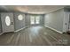 Inviting living room with gray vinyl floors, complemented by a decorative glass front door at 5458 Foxcroft Dr, Fort Lawn, SC 29714