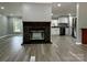 Open-concept living space featuring a stone fireplace and modern gray vinyl flooring at 5458 Foxcroft Dr, Fort Lawn, SC 29714