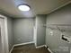 Neutral-colored utility room featuring a door, shelving, wood-look flooring, and modern lighting at 5458 Foxcroft Dr, Fort Lawn, SC 29714