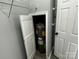 Water heater in a small closet next to storage shelves with an adjacent white paneled door at 5458 Foxcroft Dr, Fort Lawn, SC 29714