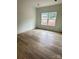 Bright, minimalist bedroom features wood floors and a large window offering plenty of natural light at 63 Cornerstone Dr, Taylorsville, NC 28681