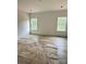A bright bedroom featuring wood floors and two large windows offering plenty of natural light at 63 Cornerstone Dr, Taylorsville, NC 28681