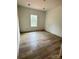 A clean bedroom with wood-look floors and natural light coming through the window at 63 Cornerstone Dr, Taylorsville, NC 28681