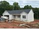 Charming single story home with light gray siding, a dark roof, and a brick foundation awaiting completion at 63 Cornerstone Dr, Taylorsville, NC 28681