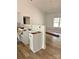 Unfinished kitchen featuring light cabinets, gold hardware and light wood floors in a home under construction at 63 Cornerstone Dr, Taylorsville, NC 28681