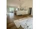 An open-concept room with hardwood floors and a modern white kitchen area featuring a breakfast bar at 63 Cornerstone Dr, Taylorsville, NC 28681