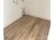 Room shows new wood-look floors; small cutout in the wall hints at possible use as storage or pet space at 63 Cornerstone Dr, Taylorsville, NC 28681