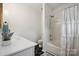 Bathroom featuring black and white tile, white cabinets, and white shower curtain at 7931 Baylis Dr, Huntersville, NC 28078
