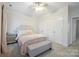 Comfortable bedroom with neutral tones, large closets, and a soft upholstered bed and bench at 7931 Baylis Dr, Huntersville, NC 28078