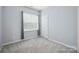 Neutral bedroom with carpet, large window with blinds, and a double-doored closet at 7931 Baylis Dr, Huntersville, NC 28078