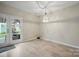 Dining area with french doors leading to outdoor patio, modern light fixture, and wood flooring at 7931 Baylis Dr, Huntersville, NC 28078