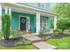 Inviting front porch with decorative plants, outdoor seating, and a charming entrance creating a warm welcome at 7931 Baylis Dr, Huntersville, NC 28078