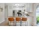 Well-equipped kitchen with island seating, stainless appliances, and bright white cabinets, perfect for Gathering gatherings at 7931 Baylis Dr, Huntersville, NC 28078
