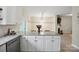 Stylish kitchen island with granite countertops, white cabinetry, and an open design flowing into the dining area at 7931 Baylis Dr, Huntersville, NC 28078