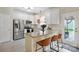 Bright kitchen with granite island, bar seating, stainless appliances, and ample storage, perfect for modern cooking at 7931 Baylis Dr, Huntersville, NC 28078