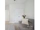Living room featuring carpet, a gray sofa, and double-doored closet at 7931 Baylis Dr, Huntersville, NC 28078