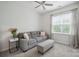 Living room with natural light and gray sofa and a neutral ottoman at 7931 Baylis Dr, Huntersville, NC 28078