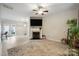 Open living room featuring a decorative fireplace, hardwood flooring, and natural light, perfect for relaxing at 7931 Baylis Dr, Huntersville, NC 28078