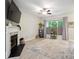 Bright living room featuring a fireplace, large window with natural light, and a ceiling fan at 7931 Baylis Dr, Huntersville, NC 28078
