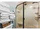 Updated bathroom with a glass door shower and built-in shelving for towels at 812 Bell Post Rd, Belmont, NC 28012