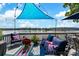 Inviting outdoor deck area with comfortable seating and patriotic decor overlooking a serene lake at 812 Bell Post Rd, Belmont, NC 28012