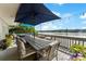 Outdoor dining on a waterfront deck with umbrella and view at 812 Bell Post Rd, Belmont, NC 28012