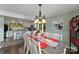 Elegant dining area adjacent to the kitchen, featuring a chandelier and a table set for a meal at 812 Bell Post Rd, Belmont, NC 28012