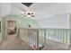 Upstairs hallway with white railing overlooking downstairs and a partial view of a room at 812 Bell Post Rd, Belmont, NC 28012