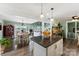 Open kitchen concept leading to the dining area with large windows showcasing lake views at 812 Bell Post Rd, Belmont, NC 28012