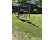 Inviting backyard with a comfortable swing set and lush green lawn, perfect for relaxing and enjoying the outdoors at 850 And 830 E Nc 152 E Hwy, China Grove, NC 28023