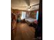 Bedroom with a wooden bed, hardwood floor and fan at 850 And 830 E Nc 152 E Hwy, China Grove, NC 28023