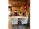 Kitchen with wood-paneled walls, tile flooring, breakfast bar, and black appliances, with bar stool seating at 850 And 830 E Nc 152 E Hwy, China Grove, NC 28023
