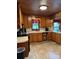 Functional kitchen with wood-paneled walls and tile flooring providing a efficient cooking space at 850 And 830 E Nc 152 E Hwy, China Grove, NC 28023