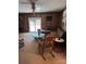 Cozy living room featuring wood paneling, rocking chair, and view to the backyard through a sliding glass door at 850 And 830 E Nc 152 E Hwy, China Grove, NC 28023