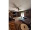 Comfortable living room with wood paneling, ceiling fans, and a large sectional sofa, creating a cozy gathering space at 850 And 830 E Nc 152 E Hwy, China Grove, NC 28023