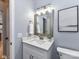 Charming bathroom featuring modern vanity, mirror, updated lighting, and tile flooring at 8608 Talbert Paige Ct, Charlotte, NC 28277