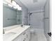 Updated bathroom featuring a double vanity with white marble countertop and tiled shower-tub at 8608 Talbert Paige Ct, Charlotte, NC 28277