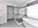 Modern bathroom showcasing a glass-enclosed shower and soaking tub at 8608 Talbert Paige Ct, Charlotte, NC 28277